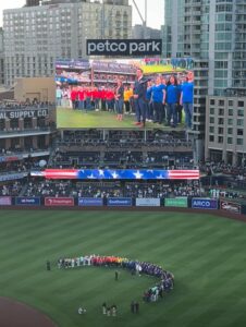 SDWC members singing on the field at Out at the Park with the San Diego Padres!